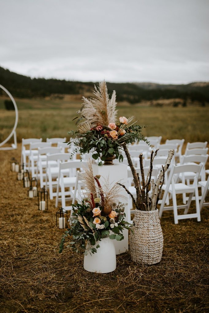 assorted vases ceremony aisle